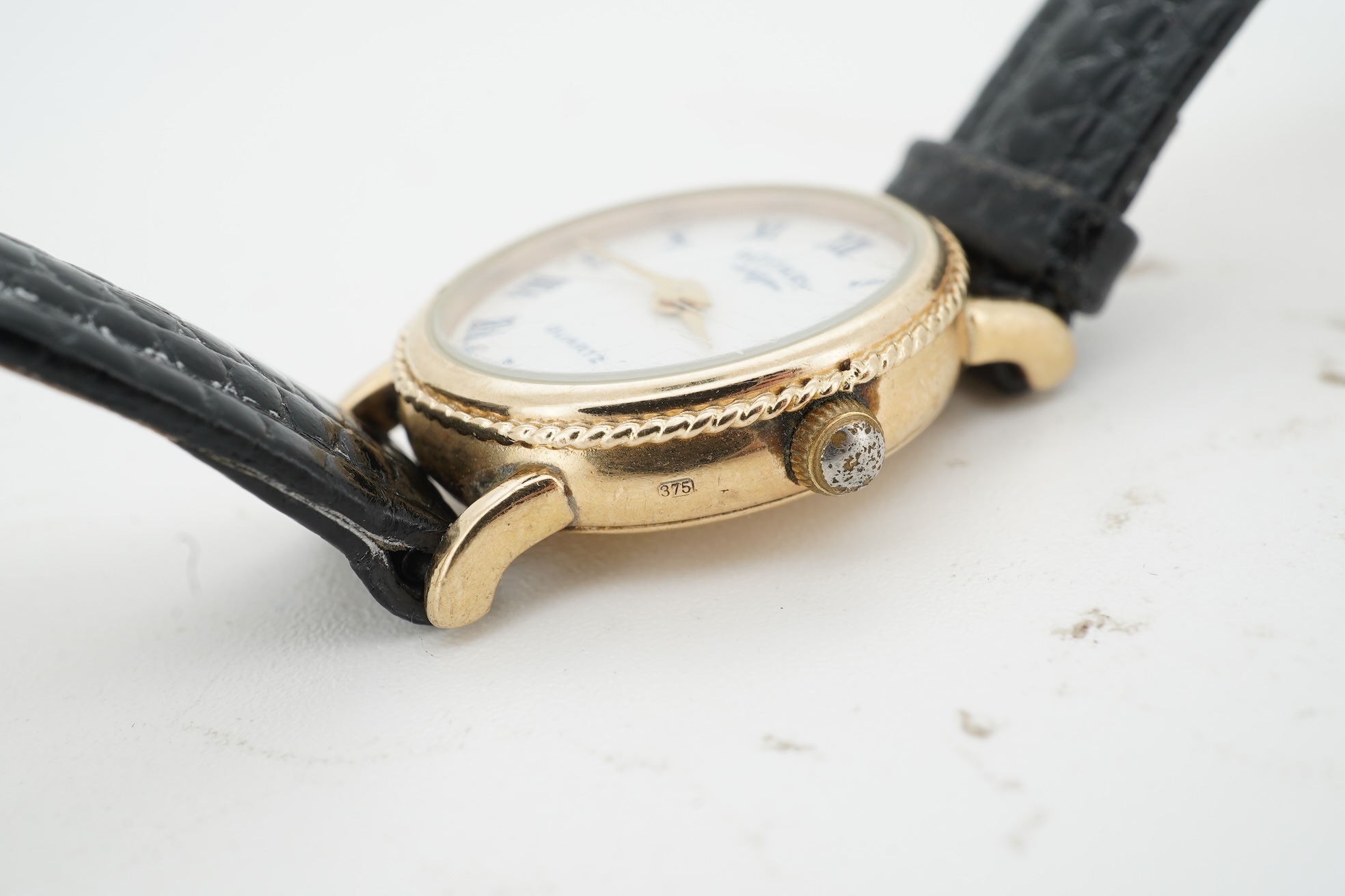 A lady's recent 9ct gold Rotary quartz wrist watch, with oval Roman dial, case diameter 18mm, on an associated leather strap, no box or papers.